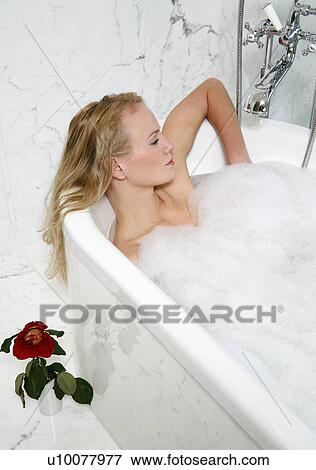 Stock Photo - Woman enjoying bubble bath. Fotosearch