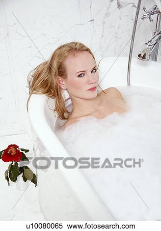 Stock Photography - Woman enjoying bubble bath. Fotosearch