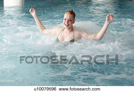 Young woman swimming in spa pool View Large Photo Image Stock Photograph - Young woman swimming in spa pool. Fotosearch