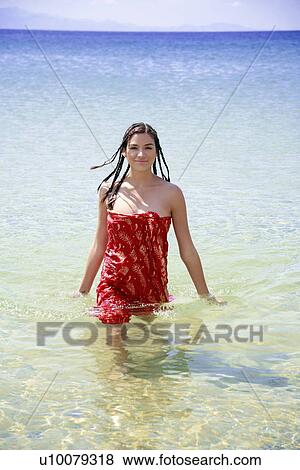 Young woman wading through water View Large Photo Image Stock Photo - Young woman wading through water. Fotosearch