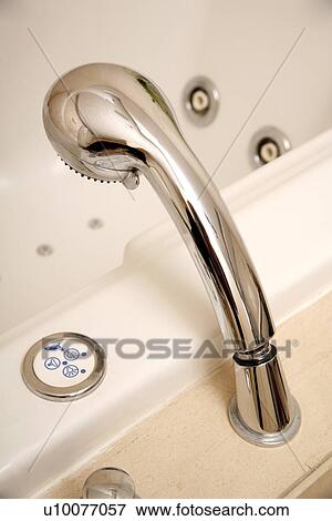 Stock Photo - Showerhead in jacuzzi tub. Fotosearch