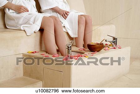 Two young women enjoying a foot bath with rose petals View Large Photo Image Stock Photograph - Two young women enjoying a foot bath with rose petals. Fotosearch