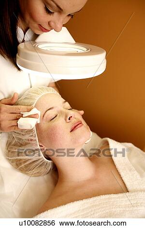 Woman having a facial treatment at a spa View Large Photo Image Stock Photograph - Woman having a facial treatment at a spa. Fotosearch