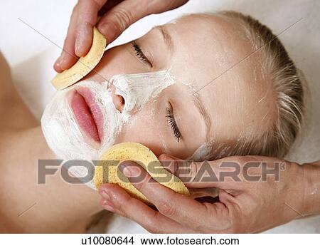 Picture - Woman having a facial treatment in a spa. Fotosearch