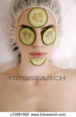 Stock Image - Woman having a facial treatment in a spa. Fotosearch