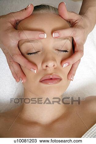 Stock Image - Woman having facial massage. Fotosearch