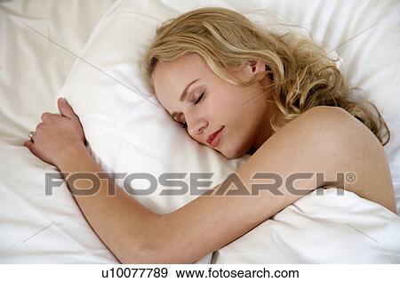 Woman sleeping in bed View Large Photo Image Stock Photo - Woman sleeping in bed. Fotosearch