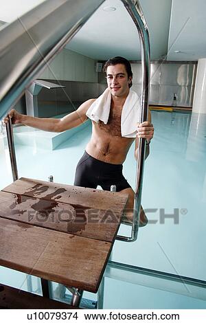 Picture - Young man in a swimming pool at a spa. Fotosearch