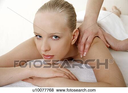 Stock Photo - Young woman enjoying a massage . Fotosearch