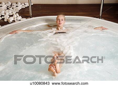 Young woman in jacuzzi at a spa View Large Photo Image Stock Image - Young woman in jacuzzi at a spa. Fotosearch