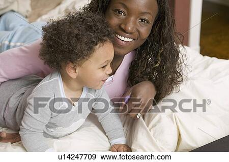 AA mom and Mulatto boy 1. 5 years old in bed. View Large Photo Image Stock Photo - AA mom and Mulatto boy 1. 5 years old in bed.. Fotosearch