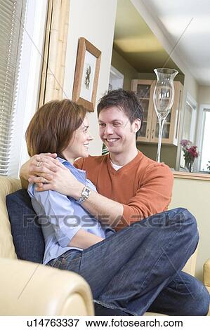 Couple embrace on sofa, Winnipeg, Canada View Large Photo Image Stock Photo - Couple embrace on sofa, Winnipeg, Canada. Fotosearch