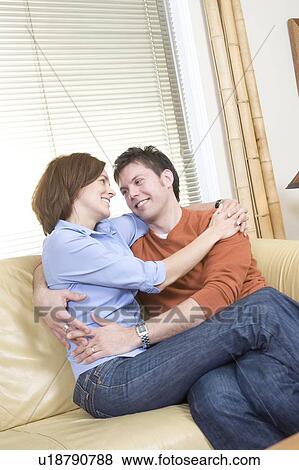 Couple embrace on sofa, Winnipeg, Canada View Large Photo Image Stock Photo - Couple embrace on sofa, Winnipeg, Canada. Fotosearch