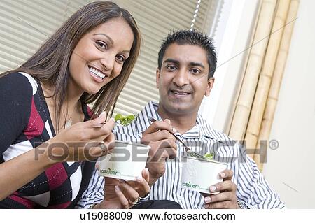Couple on sofa eating from corn-based, fully compostable, take-out containers, Winnipeg, Canada View Large Photo Image Stock Photo - Couple on sofa eating from corn-based, fully compostable, take-out containers, Winnipeg, Canada. Fotosearch