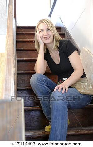 Female contractor sitting on the stairs View Large Photo Image Stock Image - Female contractor sitting on the stairs. Fotosearch
