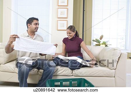 Stock Image - Man and woman folding cloth diapers, Winnipeg, Canada. Fotosearch