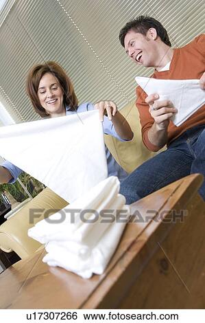 Stock Photograph - Man and woman folding cloth diapers, Winnipeg, Canada. Fotosearch