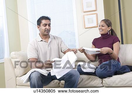 Stock Photography - Man and woman folding cloth diapers, Winnipeg, Canada. Fotosearch