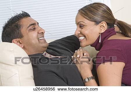 Man and woman relaxing on sofa, Winnipeg, Canada View Large Photo Image Stock Photograph - Man and woman relaxing on sofa, Winnipeg, Canada. Fotosearch