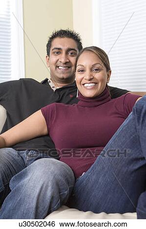 Man and woman relaxing on sofa, Winnipeg, Canada View Large Photo Image Stock Photograph - Man and woman relaxing on sofa, Winnipeg, Canada. Fotosearch