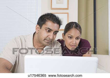 Stock Photography - Man and woman with the laptop, Winnipeg, Canada. Fotosearch