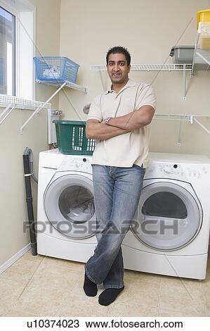 Man stands beside energy and water efficient front loading washing machine, Winnipeg, Canada View Large Photo Image Stock Image - Man stands beside energy and water efficient front loading washing machine, Winnipeg, Canada. Fotosearch