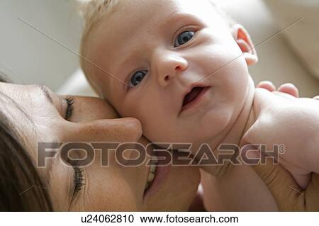 Stock Image - Mother nuzzles baby, Vancouver, British Columbia, Canada. Fotosearch