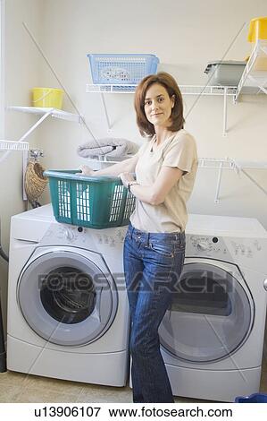 Woman in front of energy and water efficient front loading washing machine, Winnipeg, Canada View Large Photo Image Stock Photo - Woman in front of energy and water efficient front loading washing machine, Winnipeg, Canada. Fotosearch