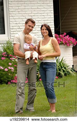 Young couple w/baby in front of house, Regina, Saskatchewan View Large Photo Image Picture - Young couple w/baby in front of house, Regina, Saskatchewan. Fotosearch