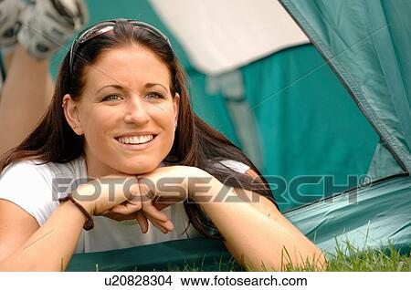 Picture - Young woman laying out front of tent, Regina, Saskatchewan. Fotosearch