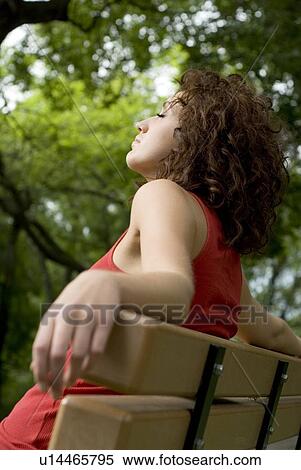 Young woman with eyes closed rests on park bench, Munson Park, Winnipeg, Canada View Large Photo Image Stock Photography - Young woman with eyes closed rests on park bench, Munson Park, Winnipeg, Canada. Fotosearch