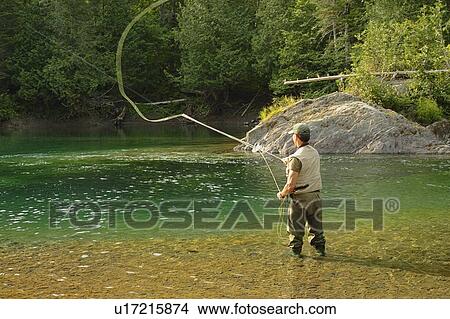 View of fisherman (salmon fishing) on Petite Cascapédia river (Arthur Rock salmon pool) View Large Photo Image Picture - View of fisherman (salmon fishing) on Petite Cascapédia river (Arthur Rock salmon pool). Fotosearch