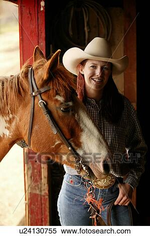 Young woman and horse in stable, Cypress Hills Interprovincial Park, Canada View Large Photo Image Stock Photography - Young woman and horse in stable, Cypress Hills Interprovincial Park, Canada. Fotosearch