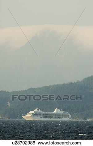 A Cruise ship passing below a large mountain; Canada, British Columbia, Nanaimo View Large Photo Image Stock Photography - A Cruise ship passing below a large mountain; Canada, British Columbia, Nanaimo. Fotosearch