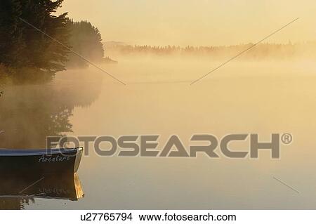 Picture - Boat and mist at Étang-à-la-Truite (Trout pond), Gaspesie, Quebec. Fotosearch