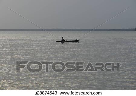 Stock Image - Canoe on lake, No motor boats allowed on Katherine L; Canada, Manitoba, Riding Mountain National Park. Fotosearch