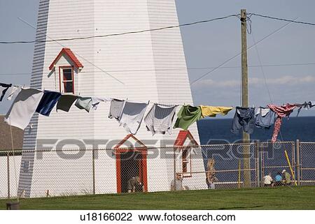 Clothes on clothesline in front of lighthouse near Basin Head, Prince Edward Island View Large Photo Image Stock Image - Clothes on clothesline in front of lighthouse near Basin Head, Prince Edward Island. Fotosearch