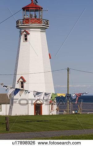 Clothes on clothesline in front of lighthouse near Basin Head, Prince Edward Island View Large Photo Image Stock Photograph - Clothes on clothesline in front of lighthouse near Basin Head, Prince Edward Island. Fotosearch