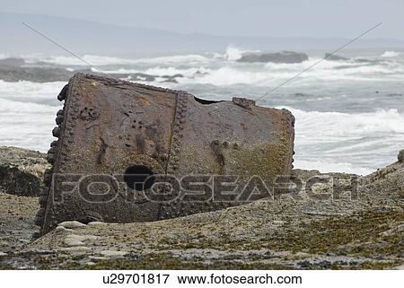 Stock Photo - Rusty Steamship Boiler that has been in this place since the ship wrecked in 1898, Pacific Rim National Park, B. C.. Fotosearch
