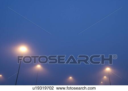 Street lights in mist at the Tsawwassen ferry terminal near Vancouver, BC View Large Photo Image Stock Image - Street lights in mist at the Tsawwassen ferry terminal near Vancouver, BC. Fotosearch