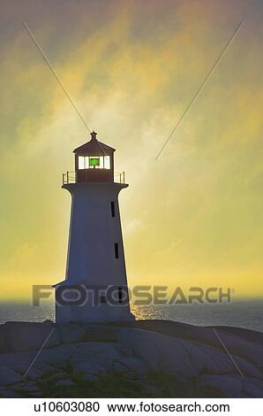 Stock Image - Sunset over Peggy's Cove Lighthouse.. Fotosearch