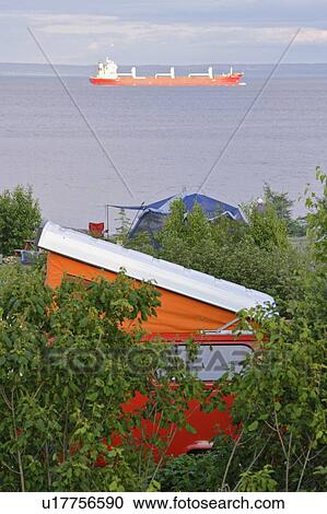 Stock Image - View of Westfalia and cargo boat on St. Lawrence River, Quebec, Canada.. Fotosearch