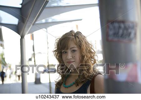 Stock Photo - Female, 17, waits at bus stop, Broadway St., Vancouver, BC. Fotosearch