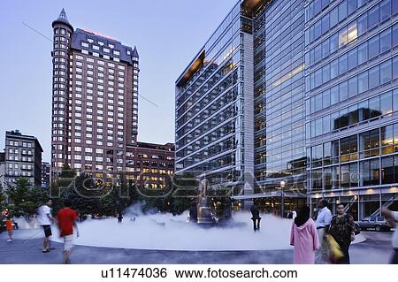 Stock Photograph - People at Place Jean-Paul-Riopelle, The Joust sculpture fountain, Quebec, Canada. Fotosearch