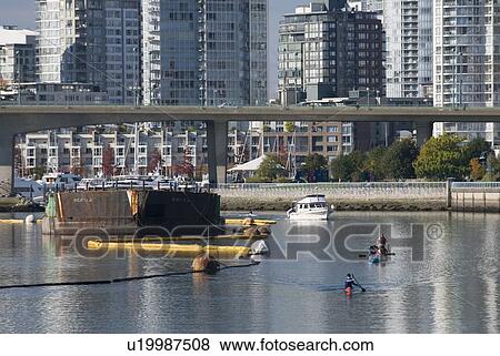 Stock Photo - Power boats and paddlers share the Vancouver waterway near False Creek. Fotosearch