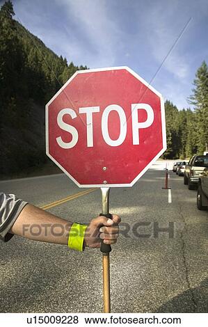 Stock Photo - Road crew stopping traffic, due to construction, British Columbia. Fotosearch