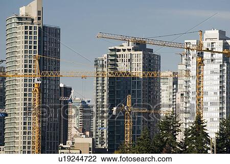 Stock Image - Skyscrapers and cranes occupy the Vancouver skyline. Housing prices are at an all-time high. Fotosearch