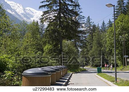 Stock Image - Waste and recycling bins, sorted into paper, glass, plastic, and garbage, Chamonix, France. Fotosearch