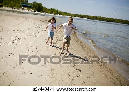 Boy (7) and girl (4) running along beach, Grand Beach Provincial Park, Manitoba, Canada View Large Photo Image Stock Image - Boy (7) and girl (4) running along beach, Grand Beach Provincial Park, Manitoba, Canada. Fotosearch