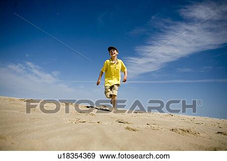 Boy (7) runs toward camera, Grand Beach Provincial Park, Manitoba View Large Photo Image Stock Photo - Boy (7) runs toward camera, Grand Beach Provincial Park, Manitoba. Fotosearch